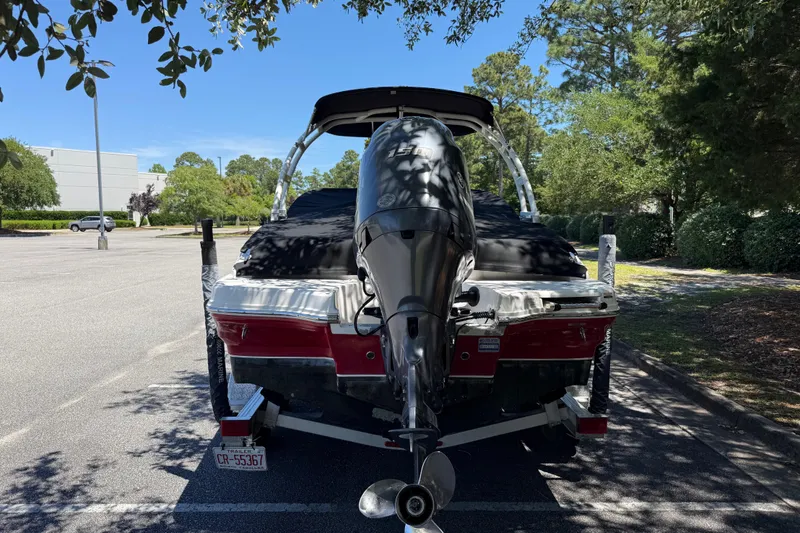 Slide: The Image of 2019 Chaparral 21 H2O Sport OB boat with outboard motor in parking lot. - 3