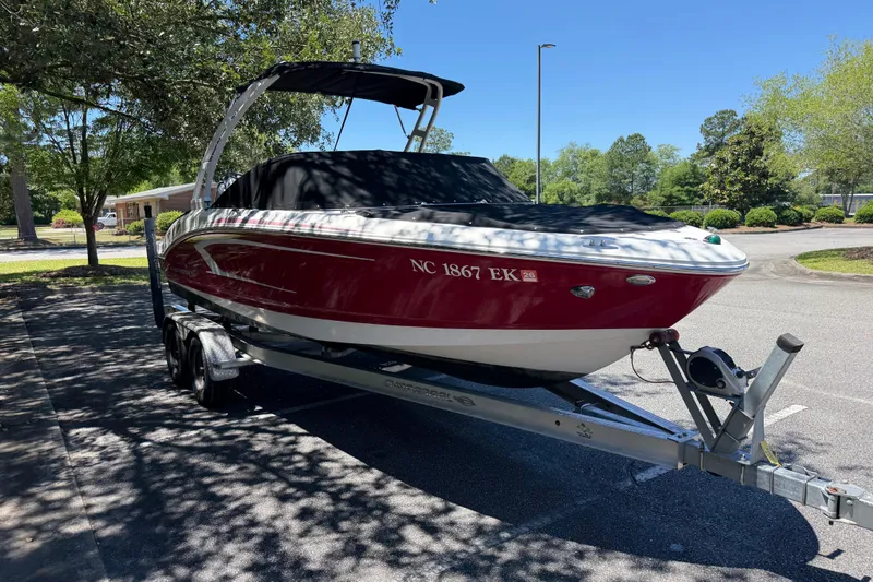 Slide: The Image of 2019 Chaparral 21 H2O Sport OB boat on trailer, parked outdoors. - 7