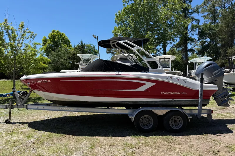 Slide: The Image of 2019 Chaparral 21 H2O Sport OB boat on trailer, red and white design, parked outdoors. - 9