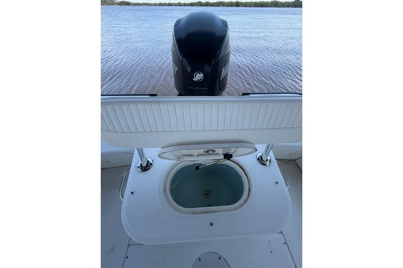 Slide: The Image of 2012 Boston Whaler 190 Montauk boat with open livewell and Mercury outboard motor. - 12