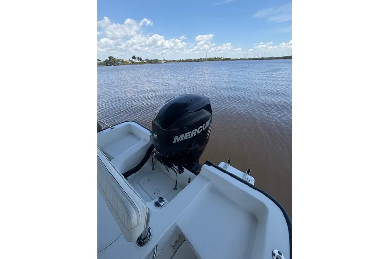 Slide: The Image of 2012 Boston Whaler 190 Montauk with Mercury engine on calm water. - 13