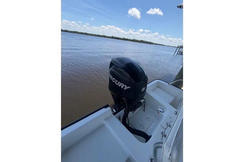 Slide: The Image of 2012 Boston Whaler 190 Montauk with Mercury outboard motor on calm water. - 14