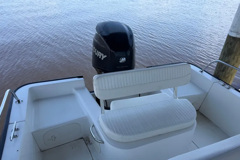 Slide: The Image of 2012 Boston Whaler 190 Montauk boat with Mercury outboard motor on calm water. - 15