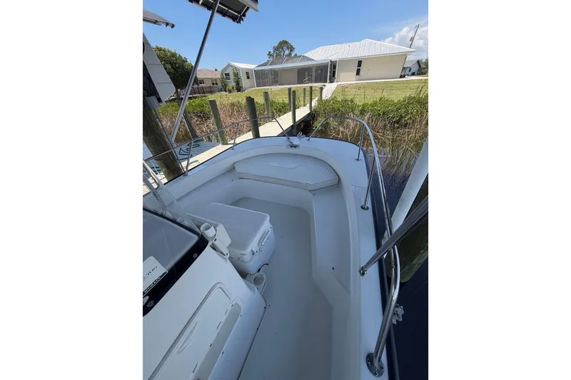 Slide: The Image of 2012 Boston Whaler 190 Montauk boat docked near waterfront homes. - 6