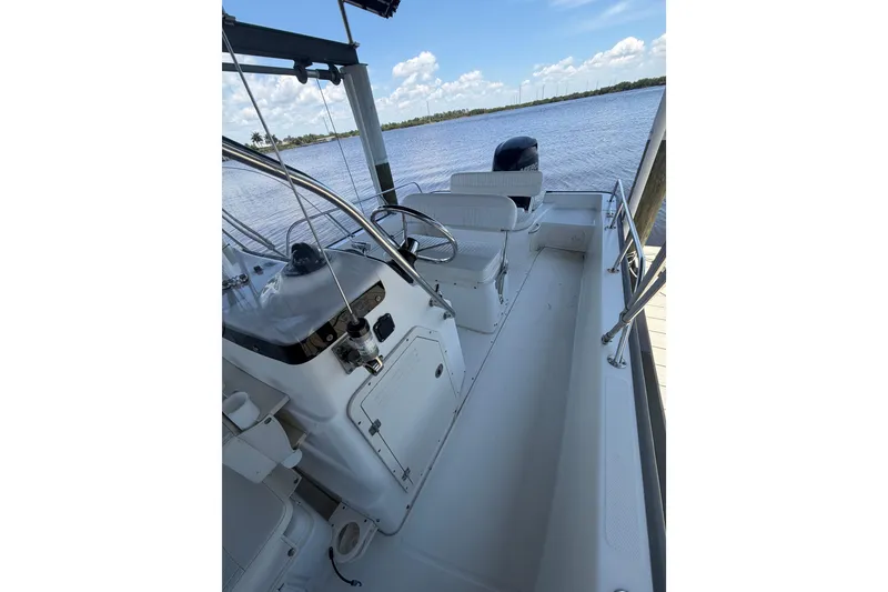 Slide: The Image of 2012 Boston Whaler 190 Montauk boat interior with steering wheel, seats, and water view. - 9