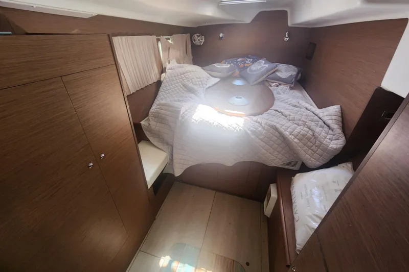 Slide: The Image of Interior cabin of a 2019 Lagoon 380 catamaran with cozy bedding and wooden finish. - 10