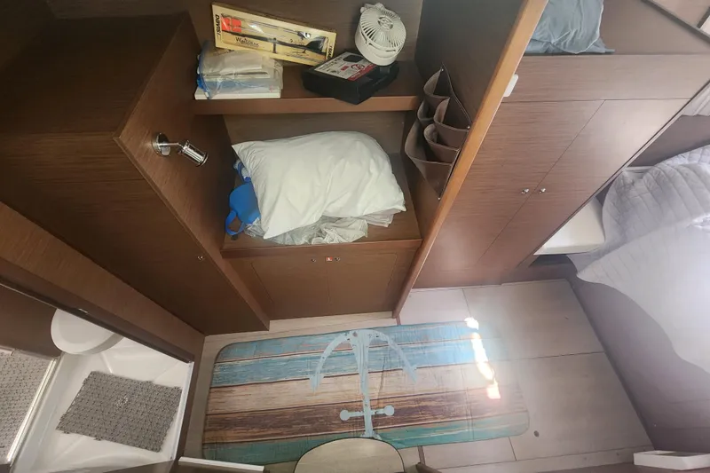 Slide: The Image of Interior of 2019 Lagoon 380 catamaran cabin with wooden storage and nautical decor. - 19