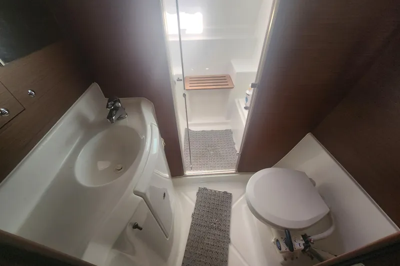 Slide: The Image of Bathroom interior of 2019 Lagoon 380 catamaran with sink, toilet, and shower area. - 21