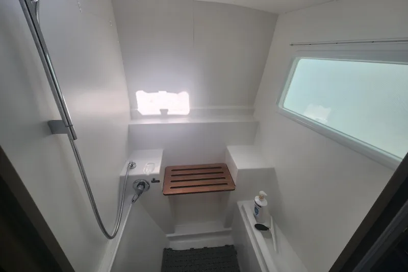 Slide: The Image of Modern bathroom interior of 2019 Lagoon 380 catamaran with shower and wooden seat. - 22