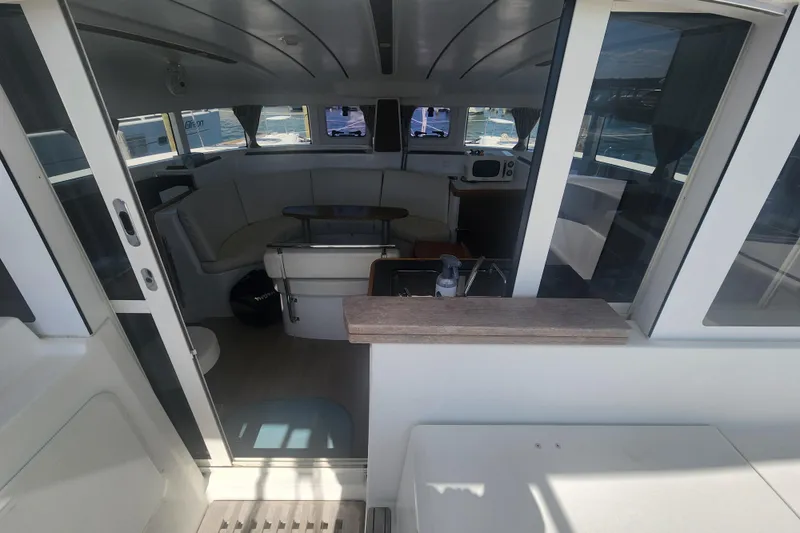 Slide: The Image of Interior view of a 2019 Lagoon 380 catamaran, featuring a spacious seating area and modern design. - 28