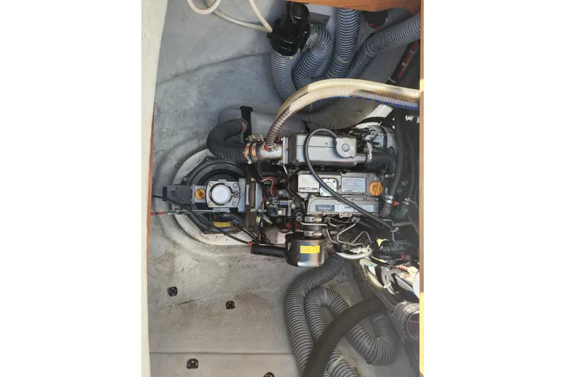 Slide: The Image of Engine compartment of a 2019 Lagoon 380 catamaran, showcasing detailed mechanical components. - 30