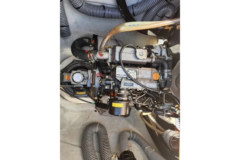 Slide: The Image of Engine compartment of a 2019 Lagoon 380 catamaran, showcasing detailed mechanical components. - 31
