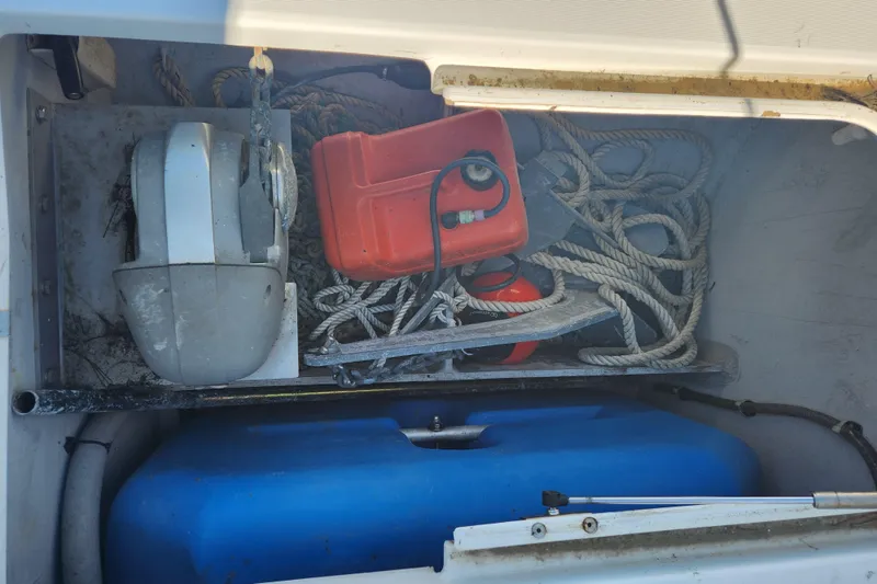 Slide: The Image of Storage compartment of a 2019 Lagoon 380 catamaran with ropes, anchor, and fuel container. - 33