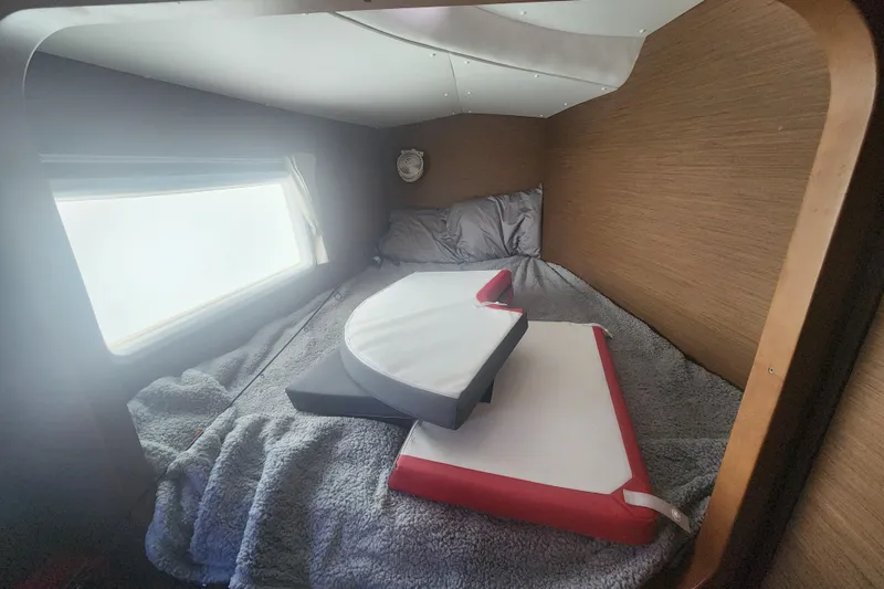 Slide: The Image of Cozy cabin interior of 2019 Lagoon 380 catamaran with bed and window view. - 7
