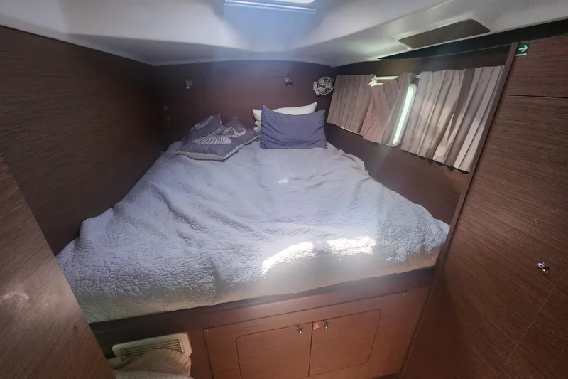 Slide: The Image of Cozy cabin interior of 2019 Lagoon 380 catamaran with comfortable bedding and wooden finish. - 8