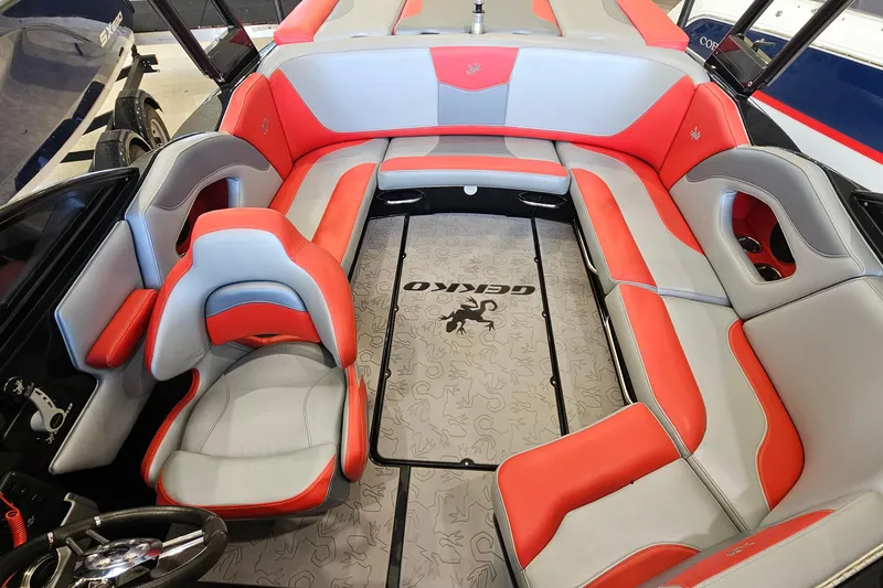 Slide: The Image of 2017 Gekko Revo 7.1 boat interior with red and gray seating, stylish design. - 10