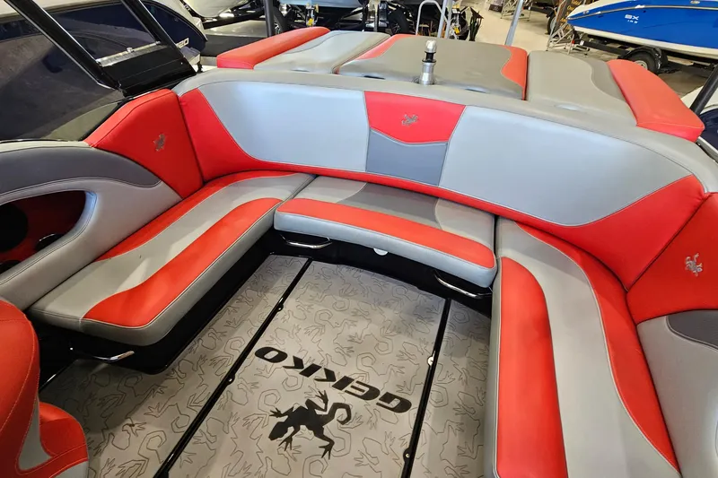 Slide: The Image of Red and gray interior of 2017 Gekko Revo 7.1 boat, featuring stylish seating. - 12