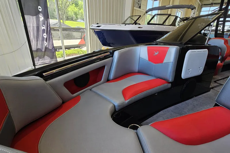 Slide: The Image of 2017 Gekko Revo 7.1 boat interior with red and gray seating in showroom. - 19