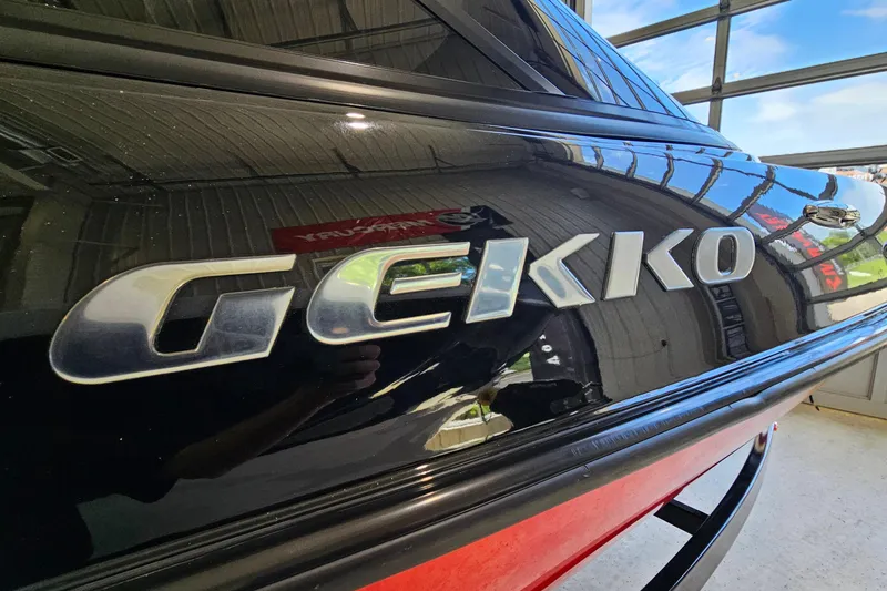 Slide: The Image of Close-up of 2017 Gekko Revo 7.1 boat logo on sleek black surface. - 25