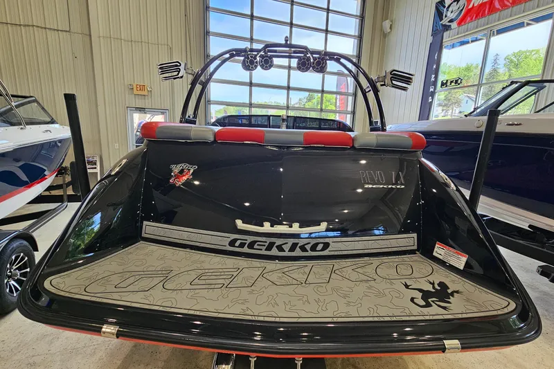 Slide: The Image of 2017 Gekko Revo 7.1 boat in showroom, rear view with branding and design details. - 5