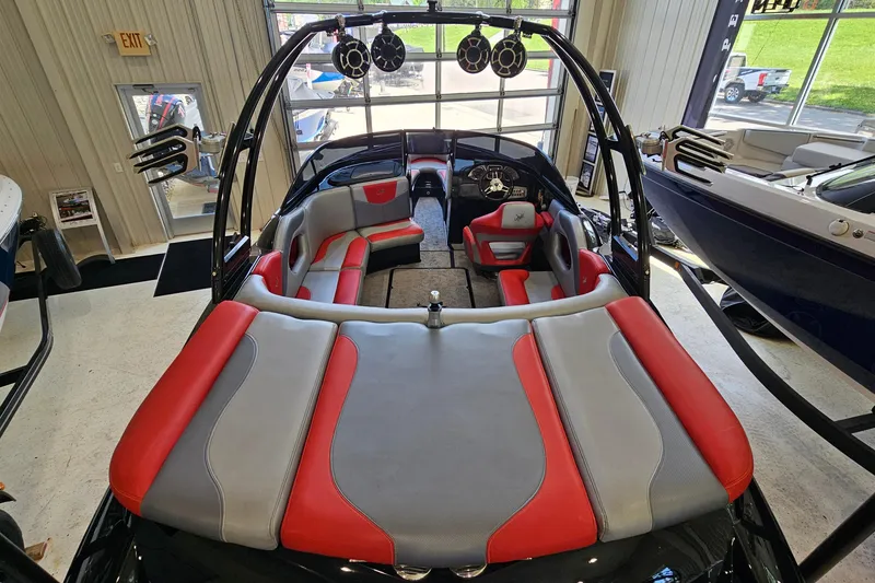 Slide: The Image of 2017 Gekko Revo 7.1 boat interior with red and gray seating, showroom display. - 8