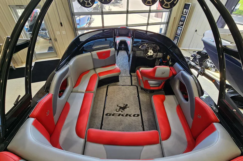 Slide: The Image of Interior of 2017 Gekko Revo 7.1 boat with red and gray seating. - 9