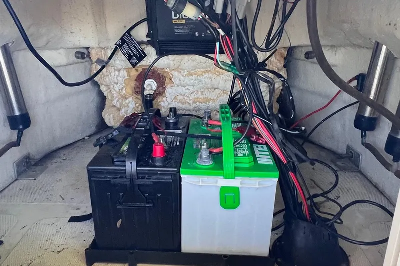 Slide: The Image of Battery compartment of a 2016 NauticStar 2110 Sport boat with wiring and components. - 14
