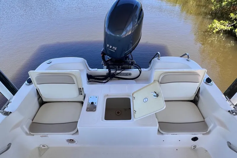 Slide: The Image of 2016 NauticStar 2110 Sport boat with Yamaha 115 engine, featuring seating and storage compartments. - 16
