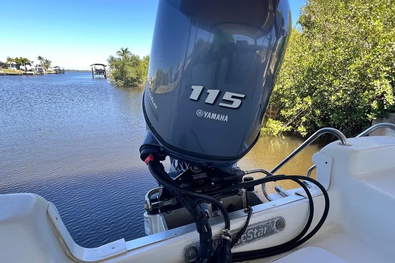 Slide: The Image of 2016 NauticStar 2110 Sport with Yamaha 115 engine on a serene waterway. - 17