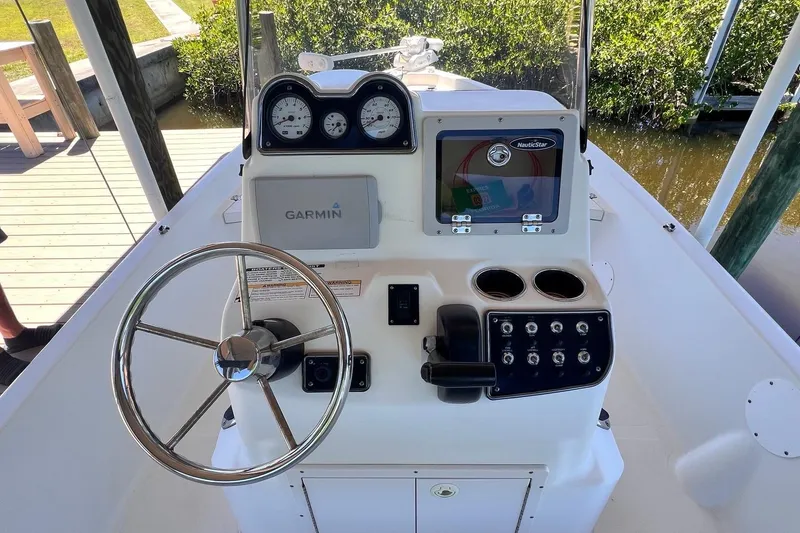 Slide: The Image of 2016 NauticStar 2110 Sport boat console with Garmin navigation and steering wheel. - 8