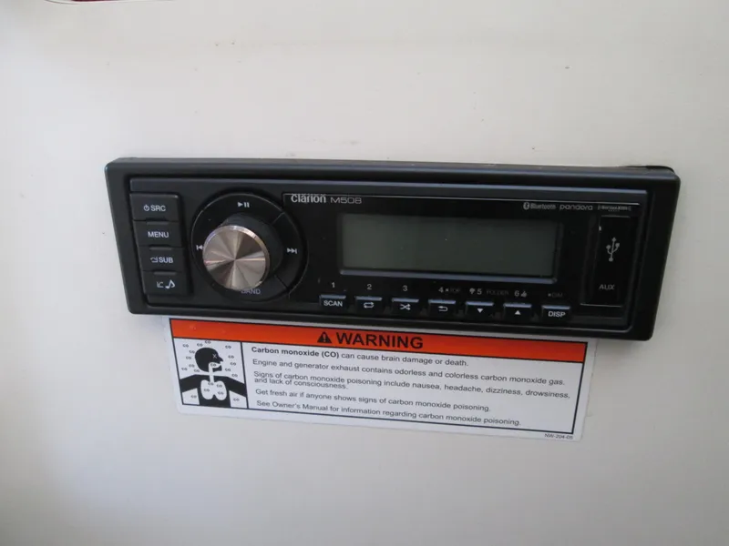 Slide: The Image of Clarion marine stereo on 1996 Sea Ray 290 Sundancer with warning label. - 10