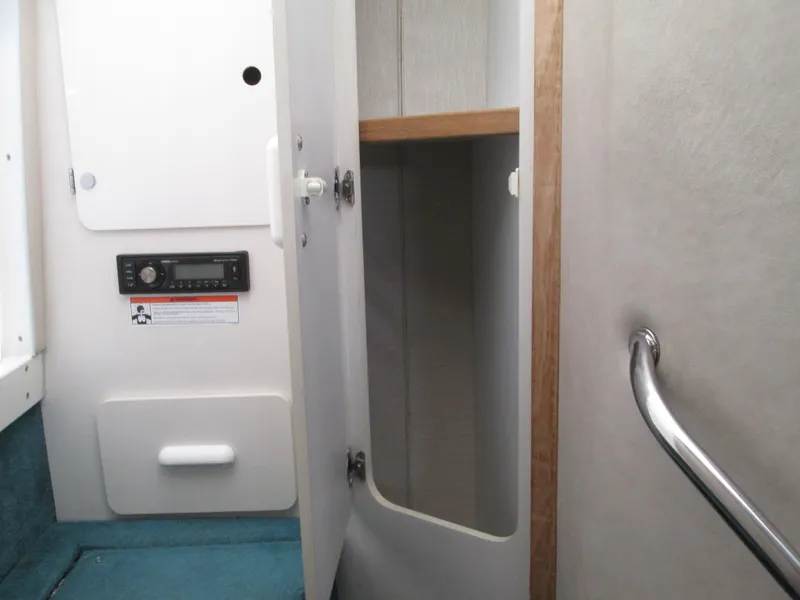 Slide: The Image of Interior of 1996 Sea Ray 290 Sundancer with storage and handrail. - 12