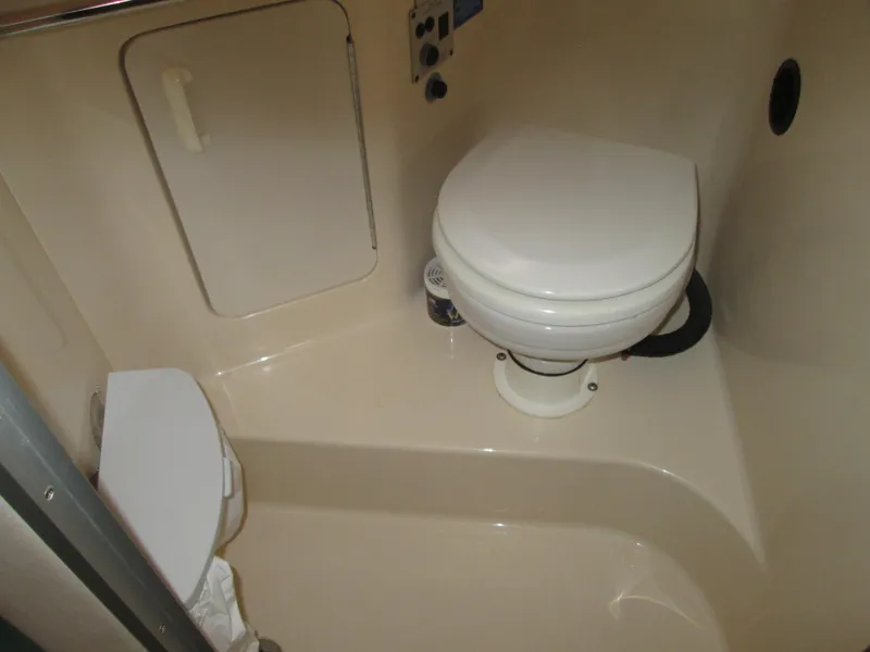 Slide: The Image of Interior of 1996 Sea Ray 290 Sundancer with toilet. - 15