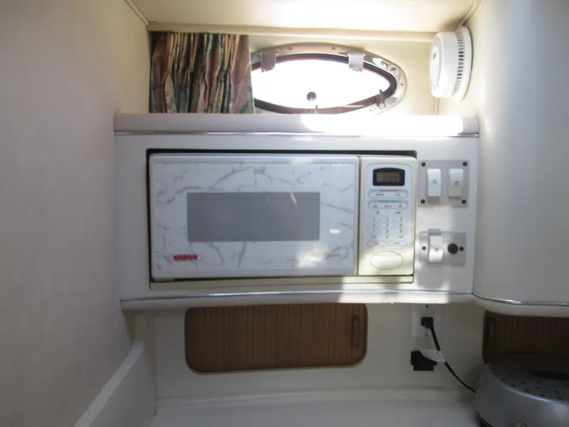 Slide: The Image of Interior of 1996 Sea Ray 290 Sundancer featuring a microwave. - 17