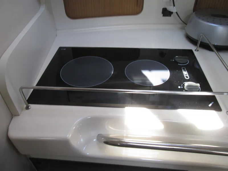 Slide: The Image of 1996 Sea Ray 290 Sundancer kitchen area with stove. - 18