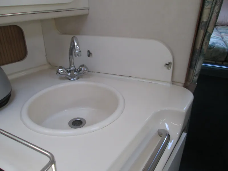 Slide: The Image of Interior of 1996 Sea Ray 290 Sundancer with sink and faucet. - 19