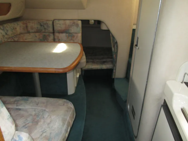 Slide: The Image of Interior of a 1996 Sea Ray 290 Sundancer with seating area and table. - 28