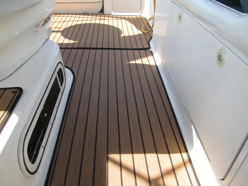 Slide: The Image of Interior of a 1996 Sea Ray 290 Sundancer with wood flooring. - 31