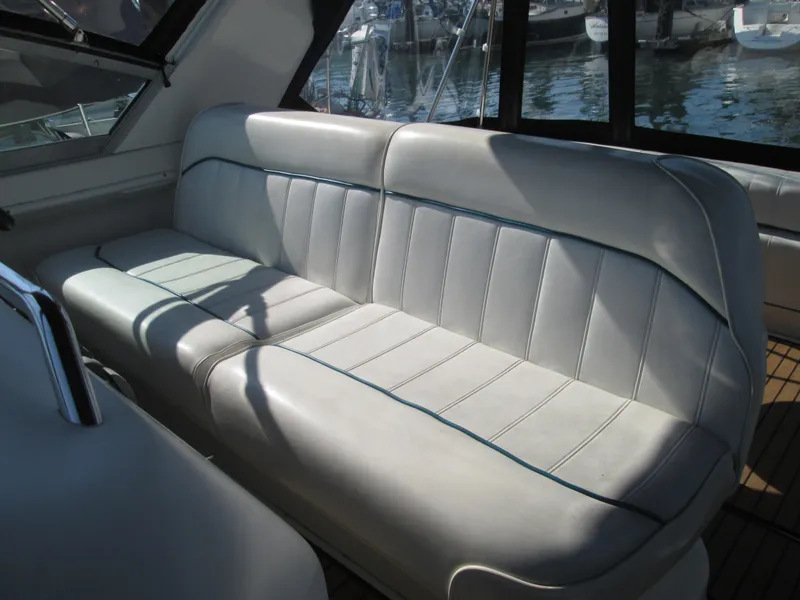 Slide: The Image of Interior of a 1996 Sea Ray 290 Sundancer with white leather seating. - 32
