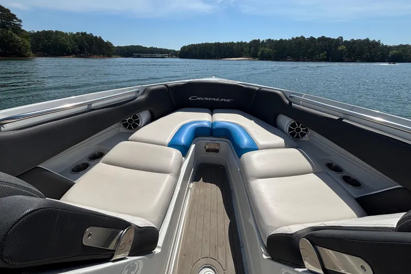 Slide: The Image of 2022 Crownline 265 SS SURF boat interior with comfortable seating on a sunny lake. - 4