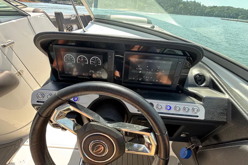 Slide: The Image of 2022 Crownline 265 SS SURF boat dashboard with dual displays and steering wheel. - 6