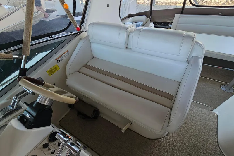 Slide: The Image of Interior of 1996 Cruisers Yachts 3570 Esprit with white seating and steering wheel. - 11