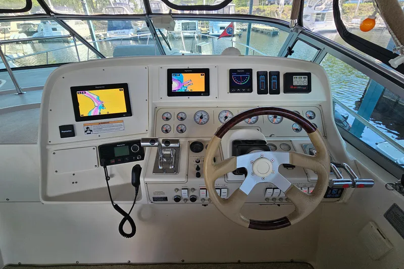 Slide: The Image of 1996 Cruisers Yachts 3570 Esprit helm with navigation screens and steering wheel. - 12