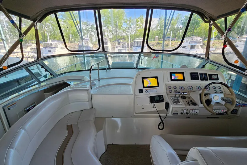 Slide: The Image of 1996 Cruisers Yachts 3570 Esprit helm with navigation instruments and comfortable seating. - 16