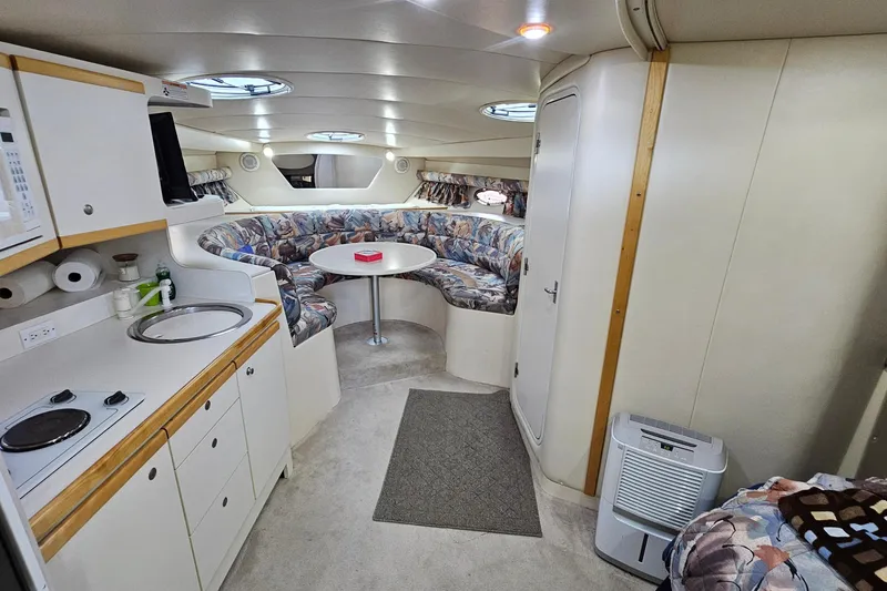 Slide: The Image of Interior of 1996 Cruisers Yachts 3570 Esprit with kitchen and seating area. - 18