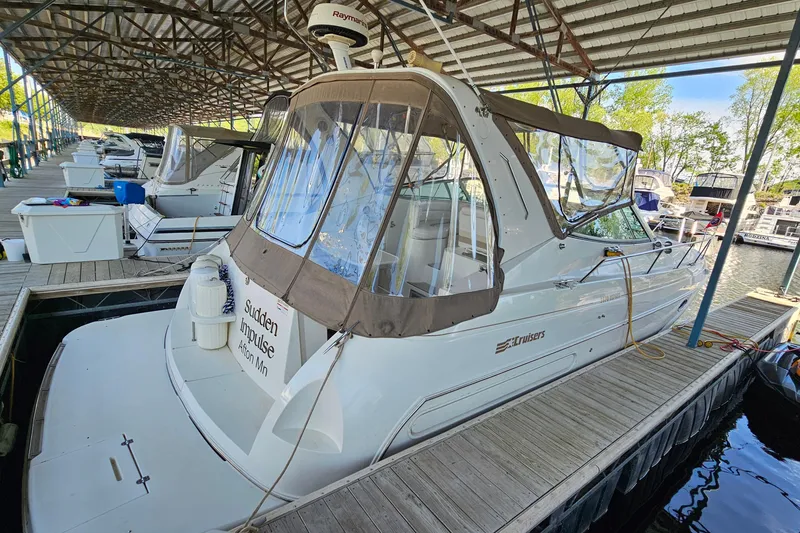 Slide: The Image of 1996 Cruisers Yachts 3570 Esprit docked in a marina under a covered structure. - 2