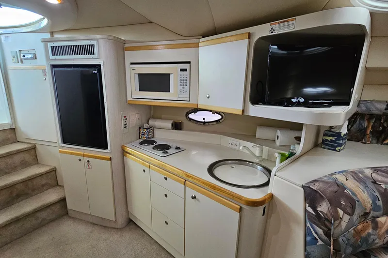 Slide: The Image of 1996 Cruisers Yachts 3570 Esprit interior with kitchenette, microwave, and TV. - 21