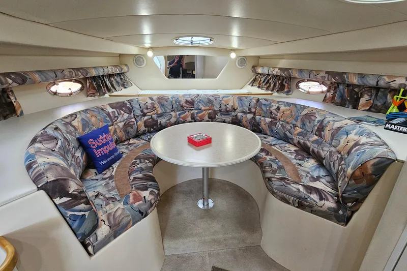 Slide: The Image of Interior of 1996 Cruisers Yachts 3570 Esprit with floral seating and round table. - 22