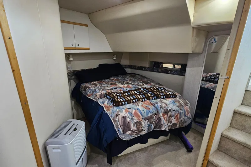Slide: The Image of Cozy cabin bedroom in 1996 Cruisers Yachts 3570 Esprit with patterned bedding and compact design. - 23