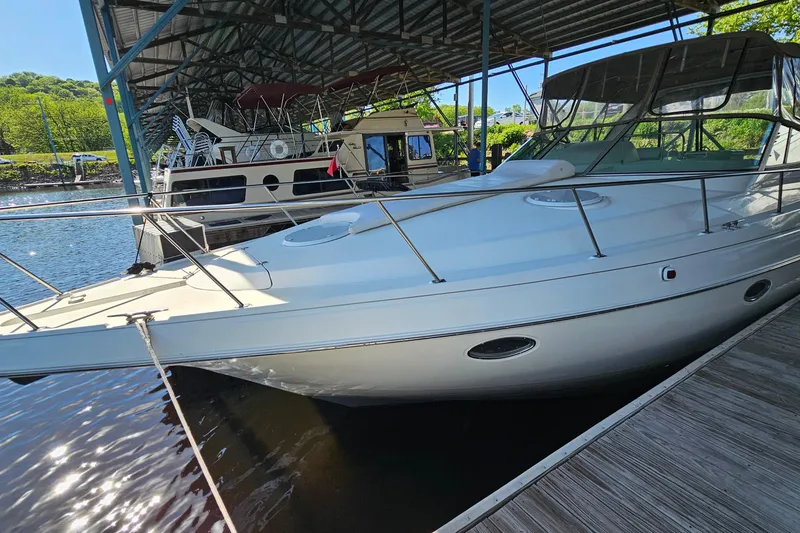 Slide: The Image of 1996 Cruisers Yachts 3570 Esprit docked under a covered marina. - 3